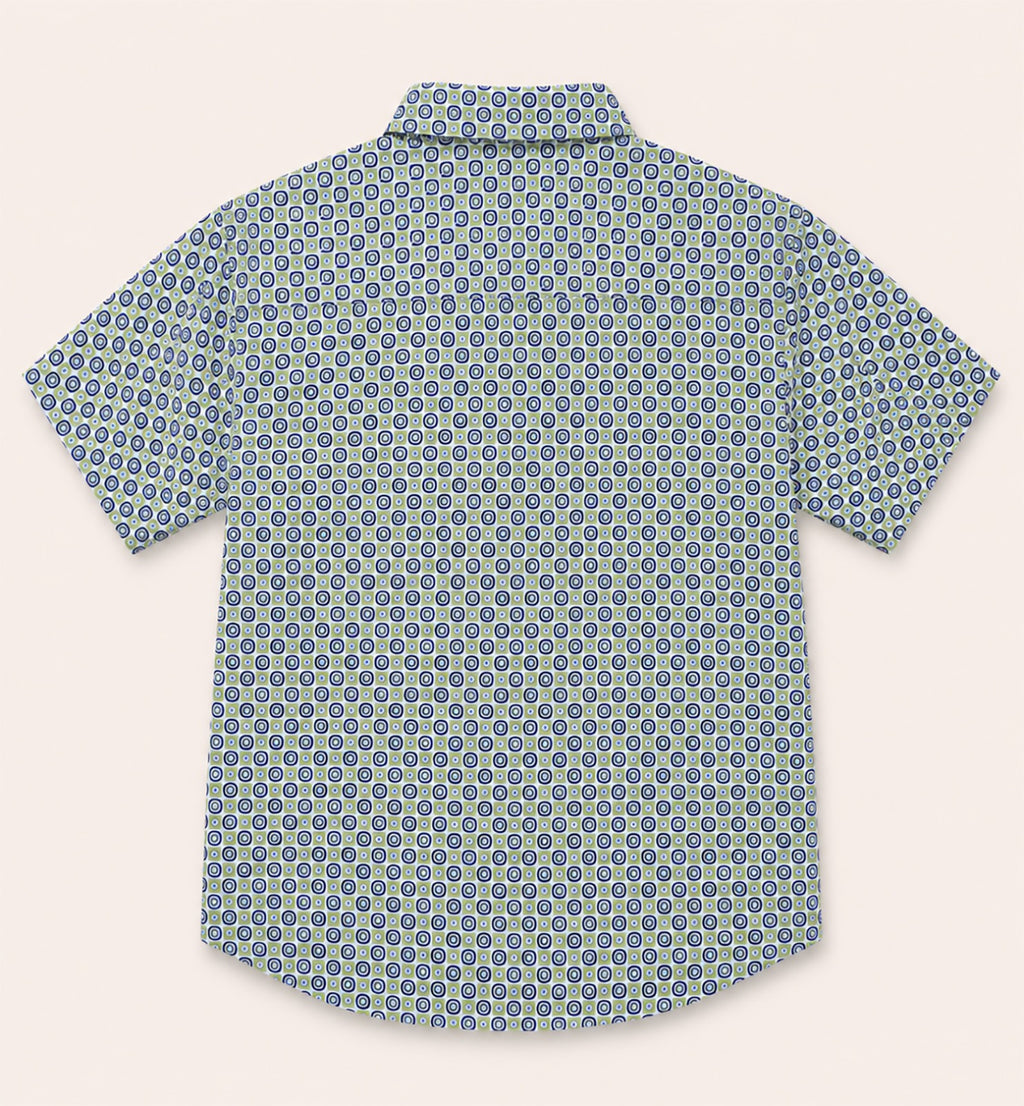 Back view of a kids short-sleeve button-down shirt showcasing the repeating green and navy retro geometric circle print.