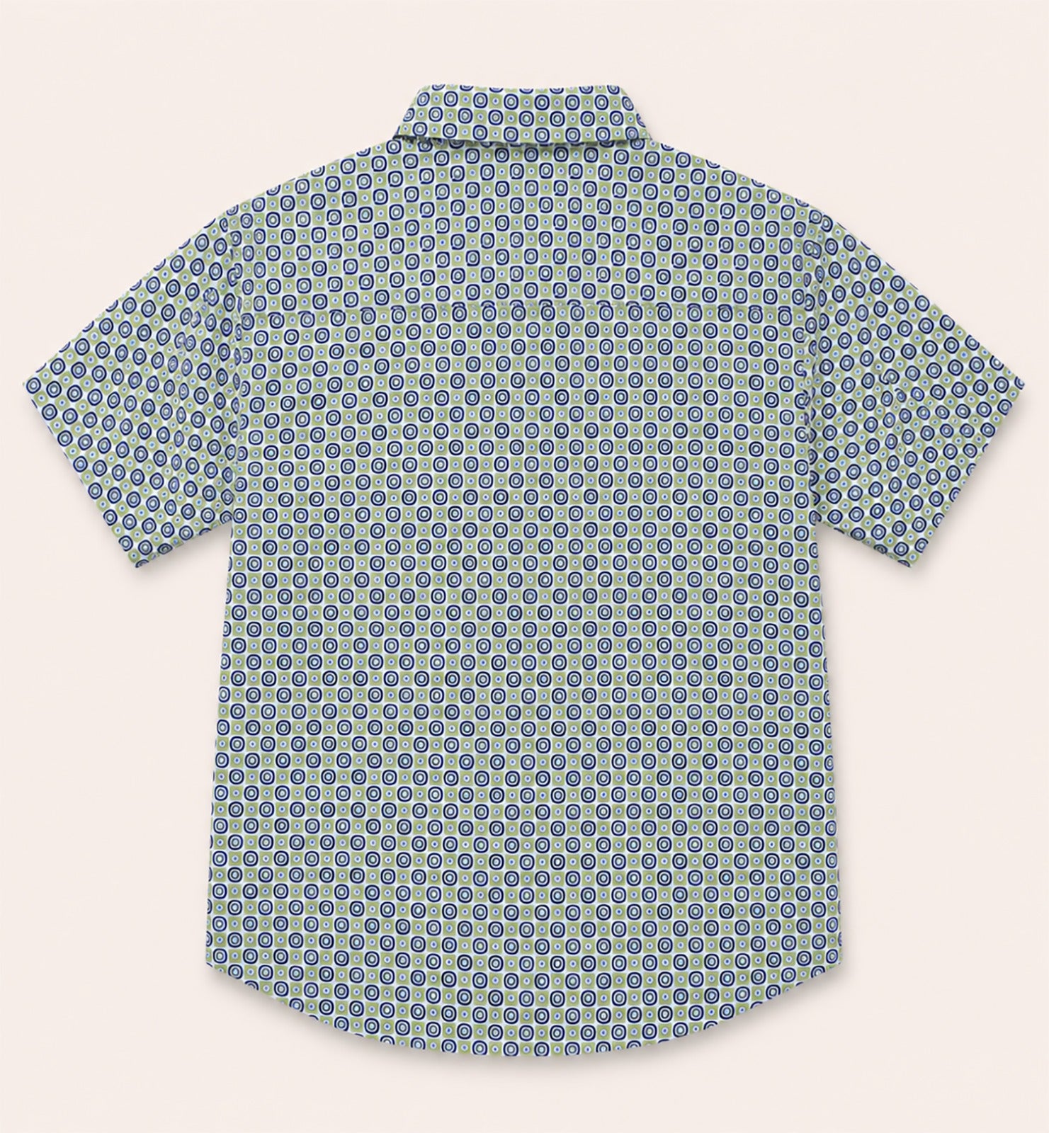 Back view of a kids short-sleeve button-down shirt showcasing the repeating green and navy retro geometric circle print.