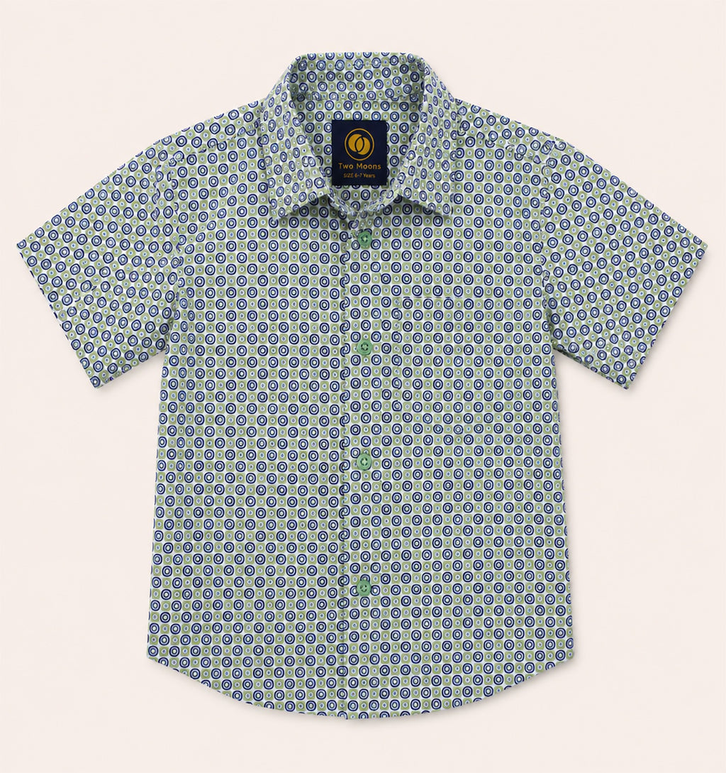 Front view of a kids short-sleeve button-down shirt featuring a green and navy blue geometric circle pattern with light green buttons.