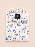 Neatly folded white kids button-down shirt highlighting the blue line-art lemon, tomato, and starfish print alongside bright blue buttons.