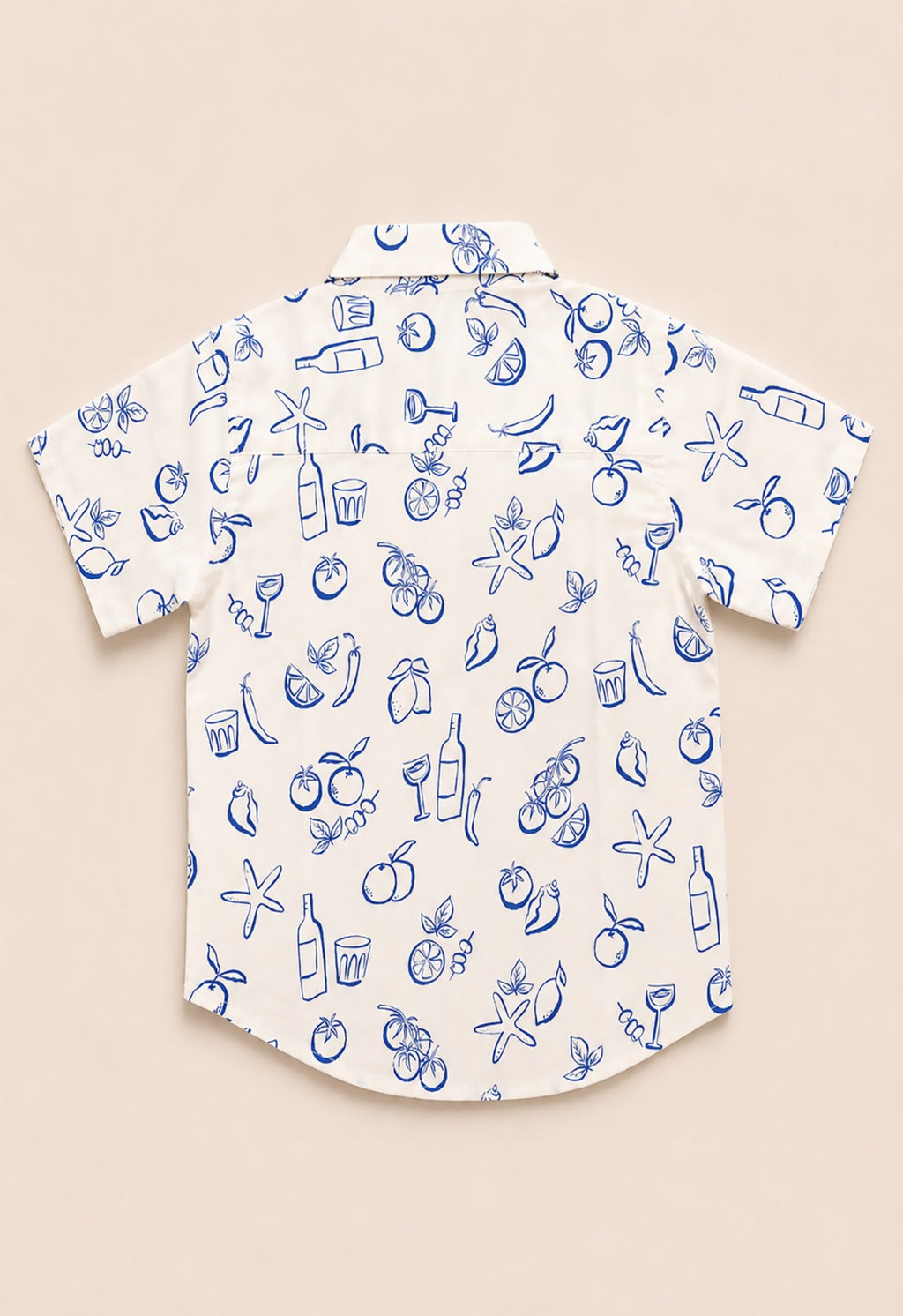 Back view of a white kids short-sleeve button-down shirt showing the blue outline Mediterranean fruit and coastal pattern.