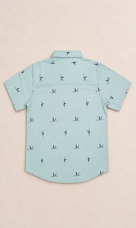 Back view of a light mint green kids short-sleeve button-down shirt showing the subtle, repeating small bird print.
