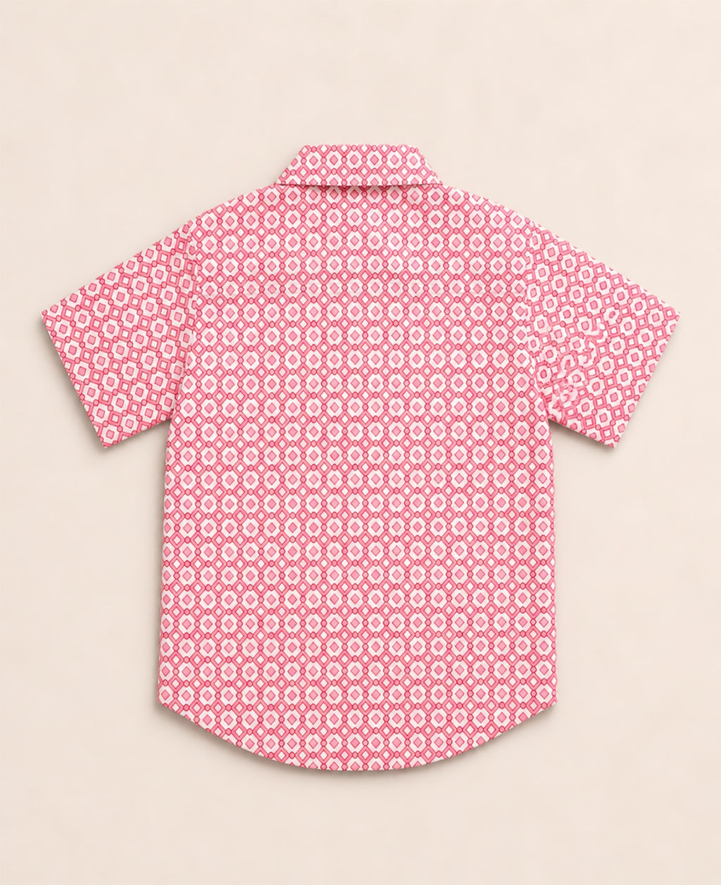 Back view of a pink and white kids short-sleeve button-down shirt showing the repeating geometric diamond print.
