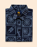 Neatly folded navy blue kids button-down shirt emphasizing the white line-art surfboard and wave print.