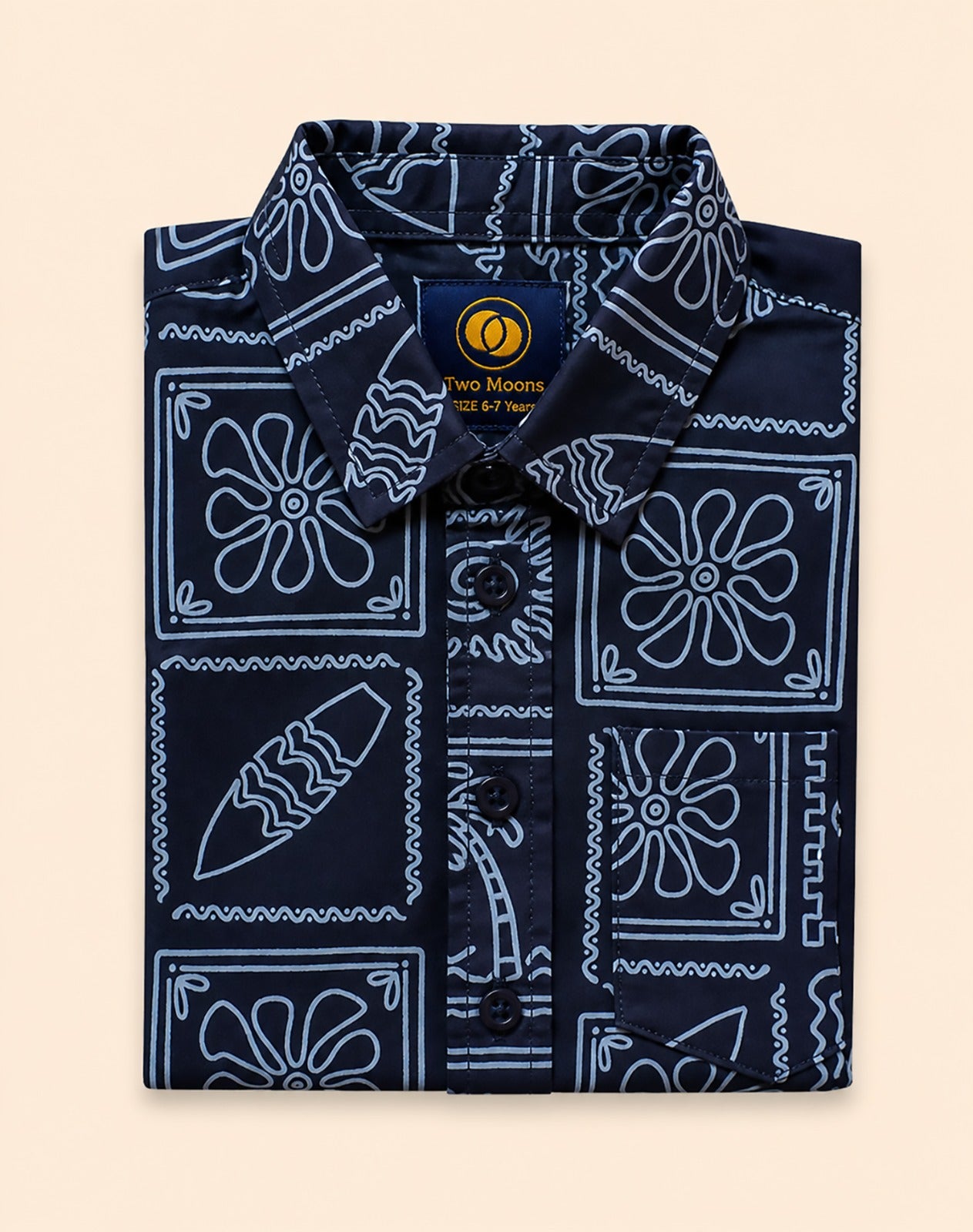 Neatly folded navy blue kids button-down shirt emphasizing the white line-art surfboard and wave print.