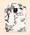 Folded Two Moons Canada kids short-sleeve button-down shirt featuring a black and white illustrated sea life print with coral and starfish.