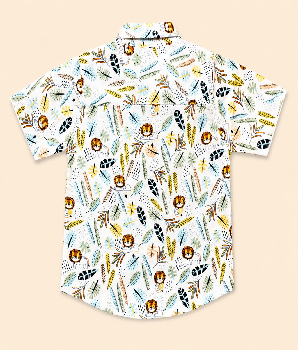 Back view of a white kids short-sleeve button-down shirt showcasing the colorful safari lion and botanical leaf print.