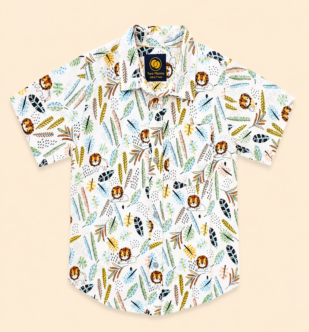 Front view of a white kids short-sleeve button-down shirt featuring a colorful safari lion and jungle botanical leaf pattern.