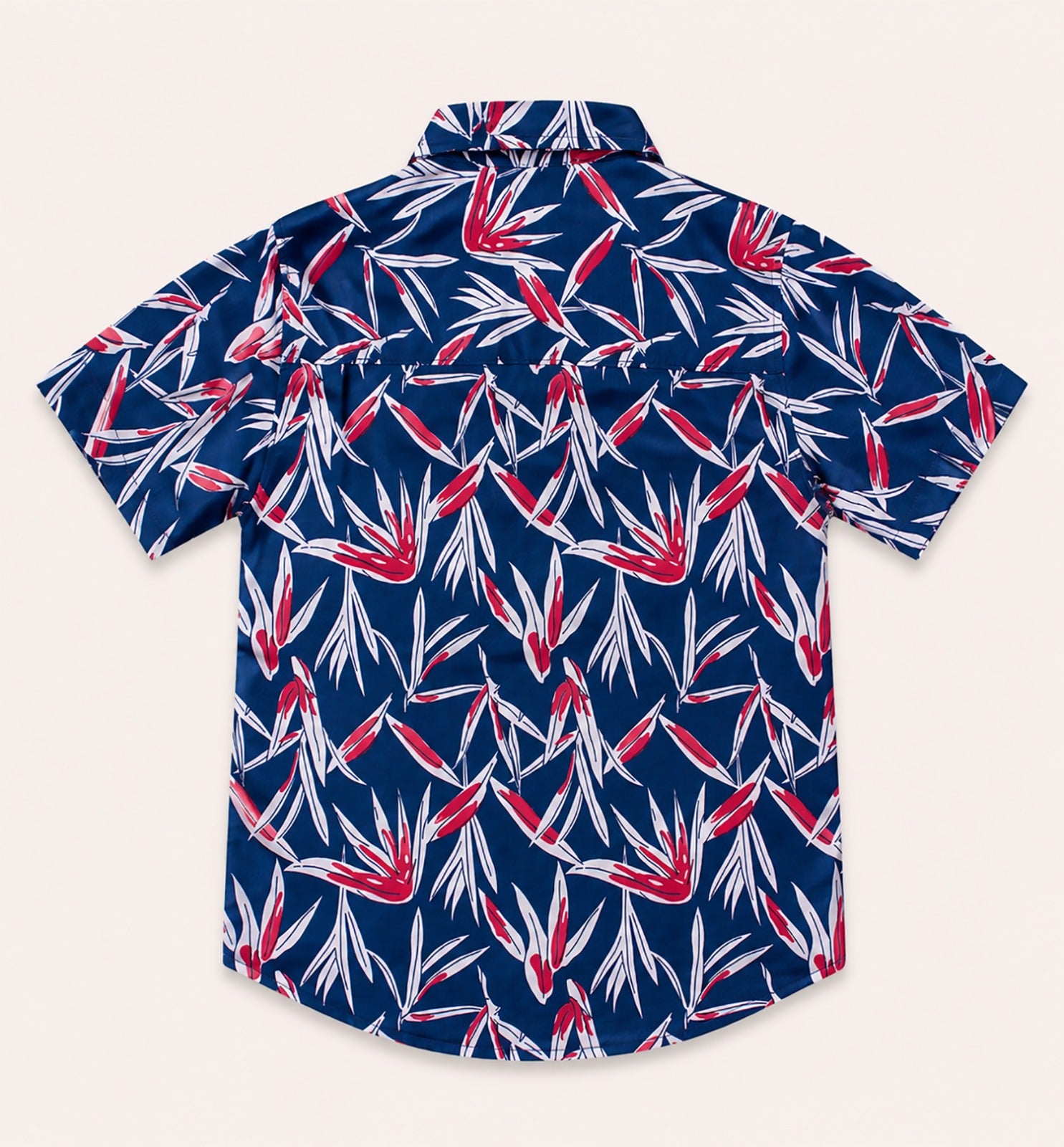 Back view of a navy blue kids short-sleeve button-down shirt showcasing the high-contrast red and white tropical leaf pattern.
