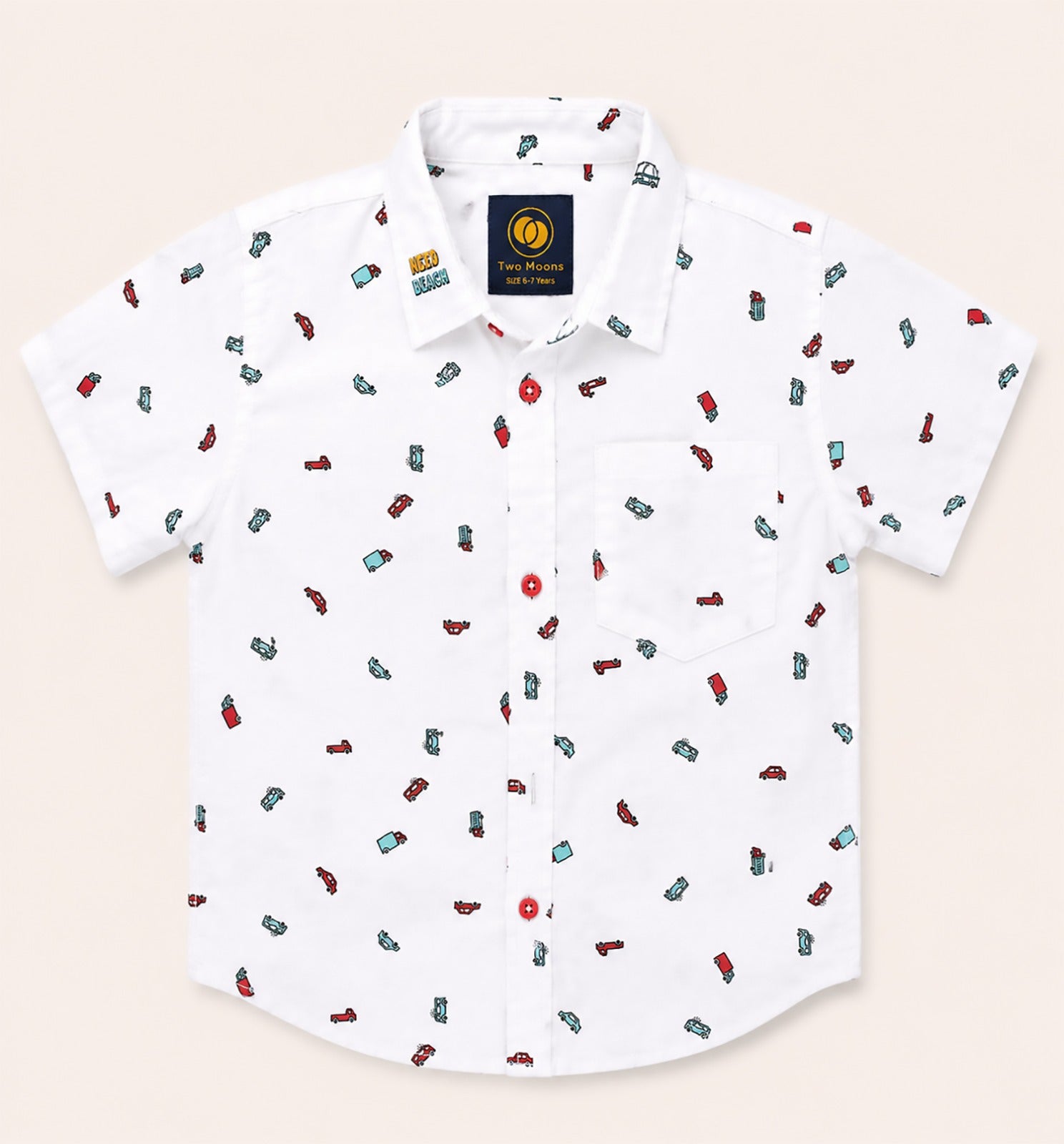 Front view of a white kids short-sleeve button-down shirt featuring a colorful pattern of toy cars and trucks with bold red buttons.