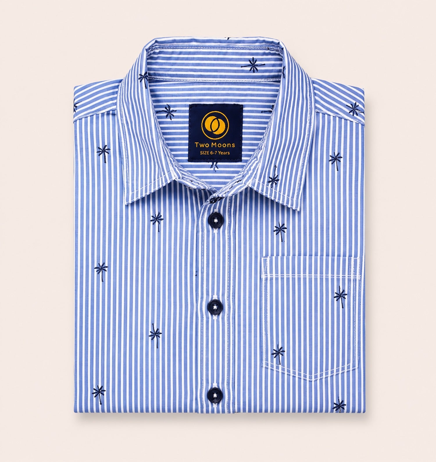 Neatly folded light blue and white striped kids button-down shirt highlighting the small palm tree motif and contrasting dark navy buttons.