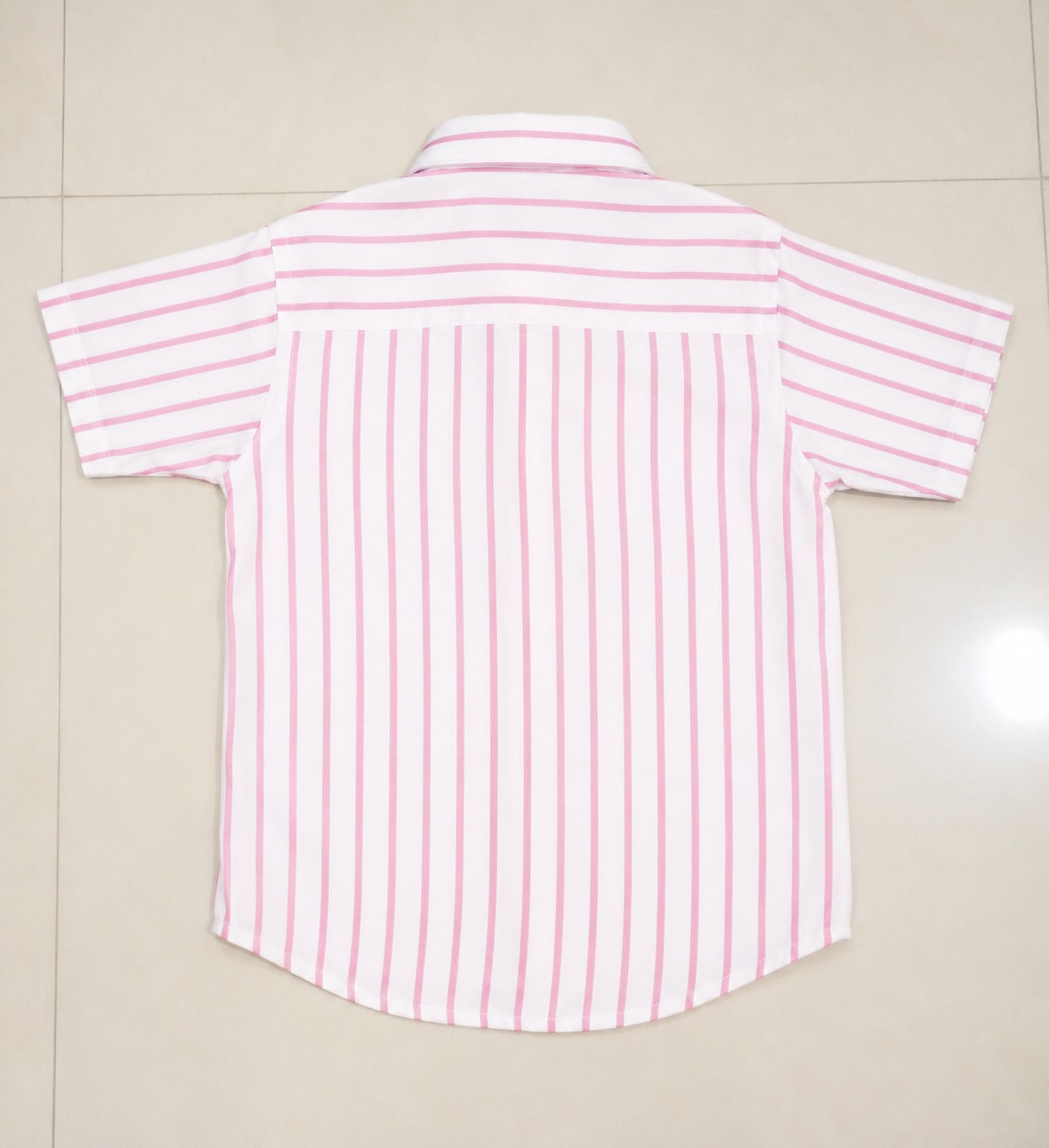 Back view of a kids short-sleeve button-down shirt showcasing the timeless pink and white vertical stripe print.
