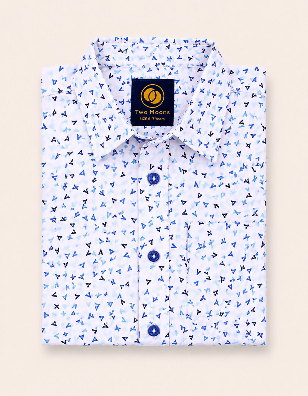 Neatly folded white kids button-down shirt highlighting the delicate blue abstract confetti pattern and contrasting dark navy buttons.