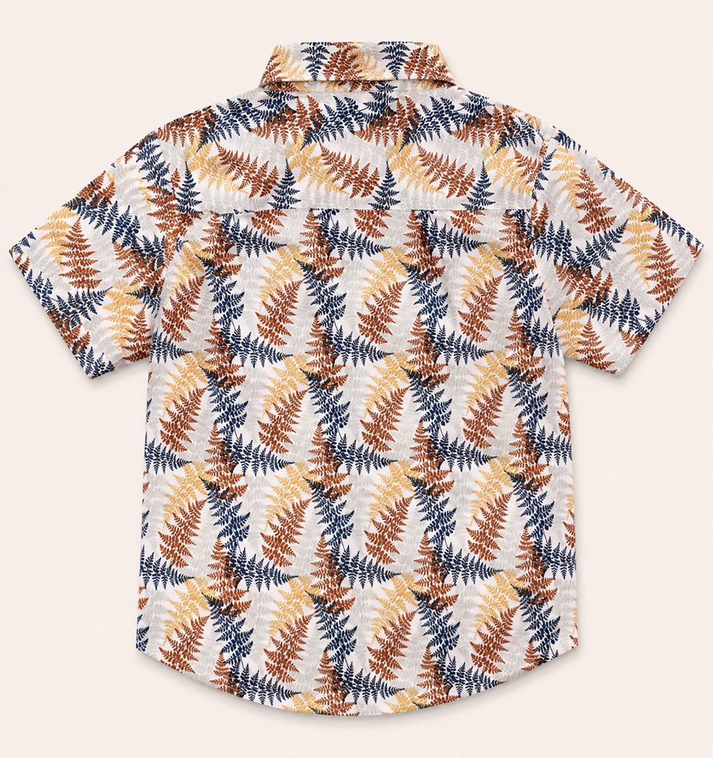 Back view of a cream kids short-sleeve button-down shirt showing the repeating earthy botanical fern leaf pattern.