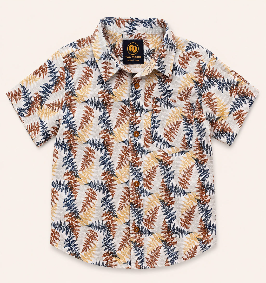 Front view of a cream kids short-sleeve button-down shirt featuring an earthy rust, yellow, and navy botanical fern print.